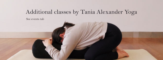 Yoga teacher, Tania Alexander in supported child's pose, a kneeling forward fold onto bolster